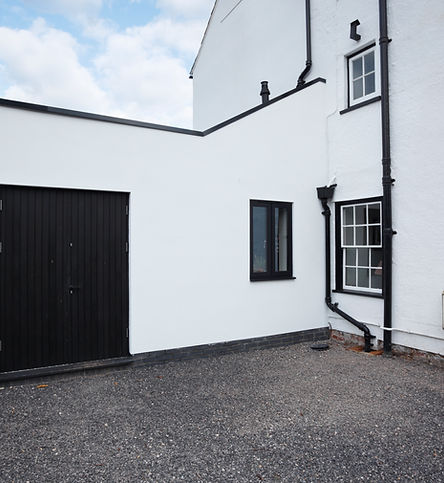 white house extension with black doors and window frames