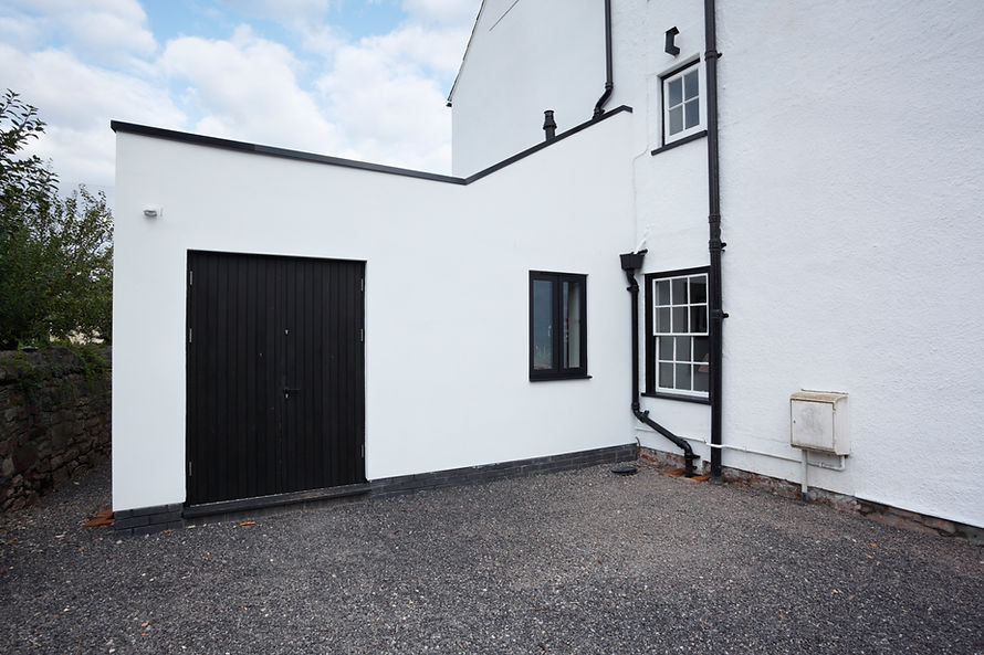 Small extension on a white house