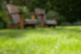 Empty lawn chairs in backyard