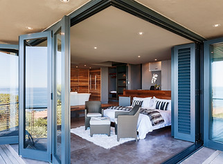Doors on patio open to modern bedroom