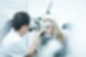 Optician and patient in eye clinic