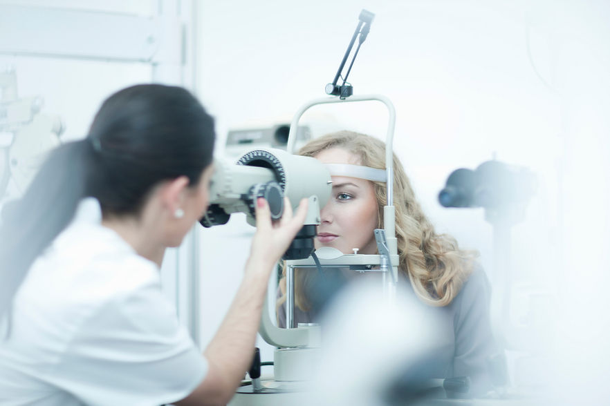 Optician and patient in eye clinic