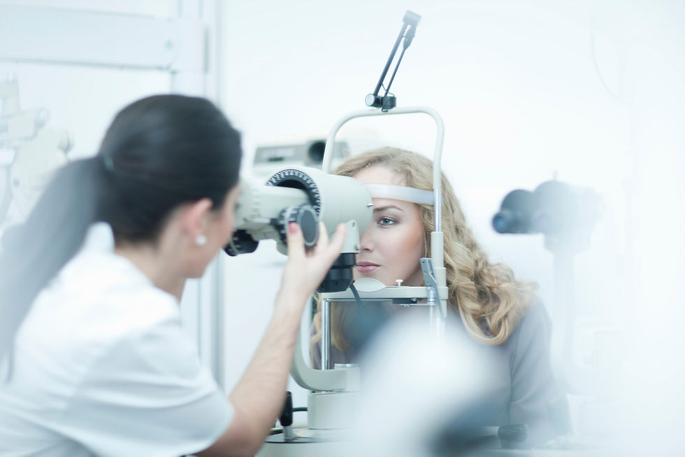 Optician and patient in eye clinic