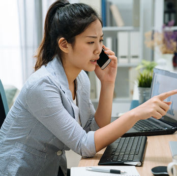 A professional on the phone explaining an Explanation of Benefits (EOB) to a client.