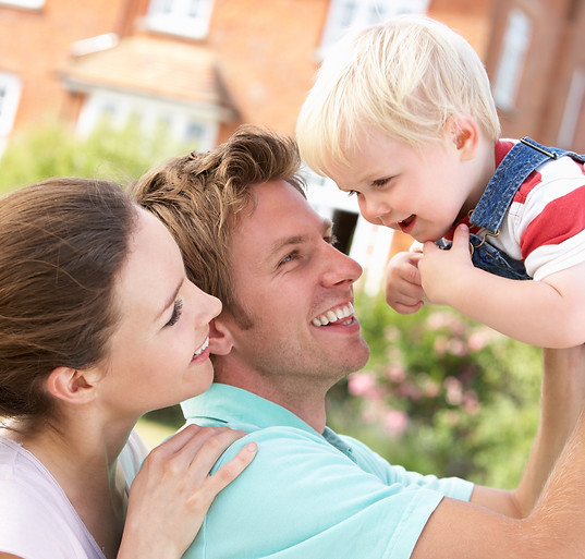 Family Playing Together In Garden At Home