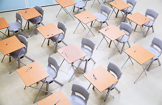 Rows of desks and chairs in empty classroom