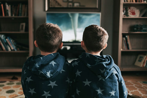 Two children watching tv