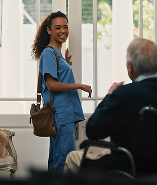 Nurse greeting elderly man