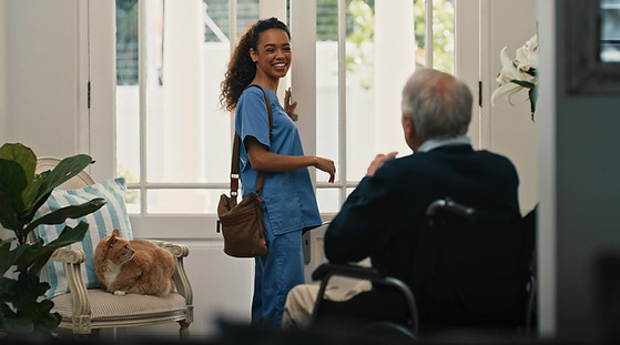 Nurse greeting elderly man