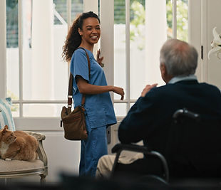 Nurse greeting elderly man