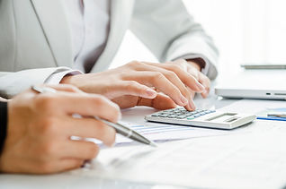 A person calculates finances with a calculator