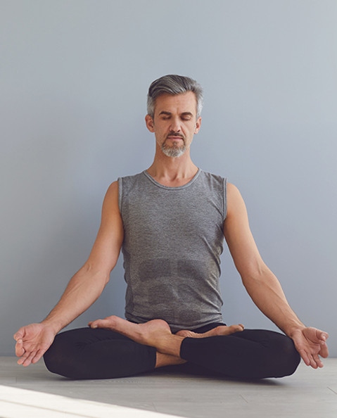 Man meditating indoors