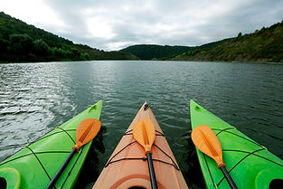 Three kayaks on water