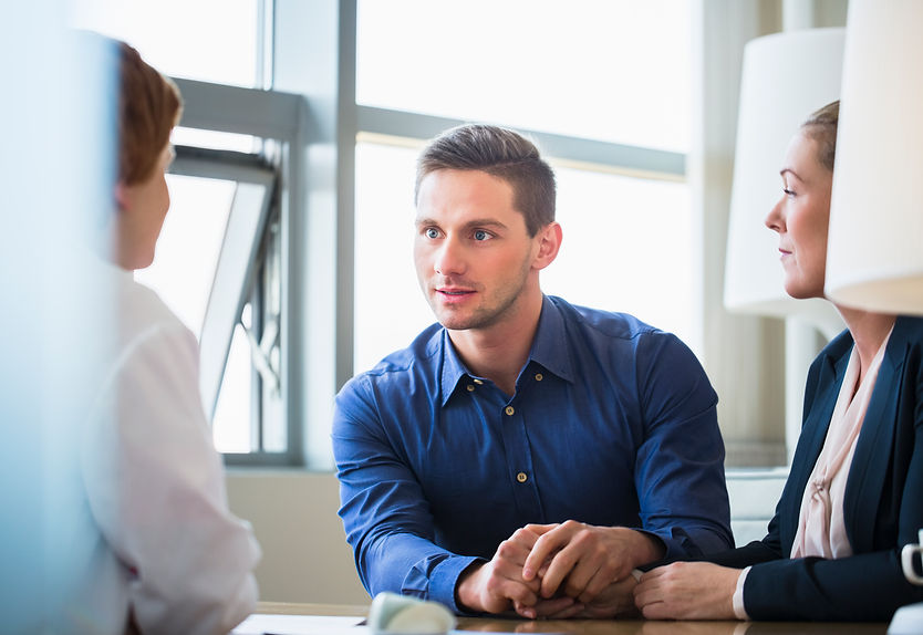 Couple consulting female doctor in clinic