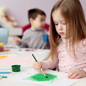 A toddler Girl Painting with Brush