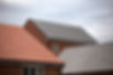 Modern residential houses with newly installed tiled roofs