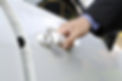Chauffeur or driver hand opening white car door