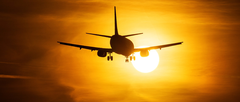 Airplane Taking Off at Sunset