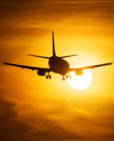 Airplane Taking Off at Sunset