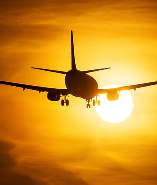 Airplane Taking Off at Sunset