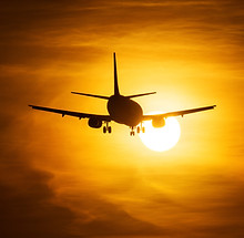 avião decolando ao pôr do sol