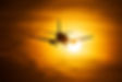 Airplane Taking Off at Sunset