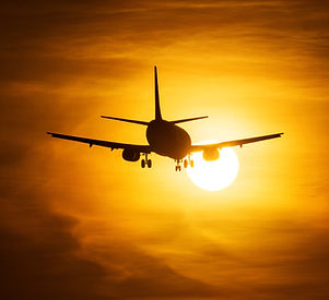 Airplane Taking Off at Sunset