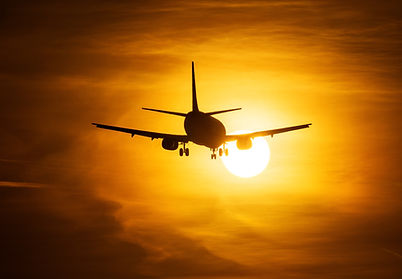 Airplane Taking Off at Sunset