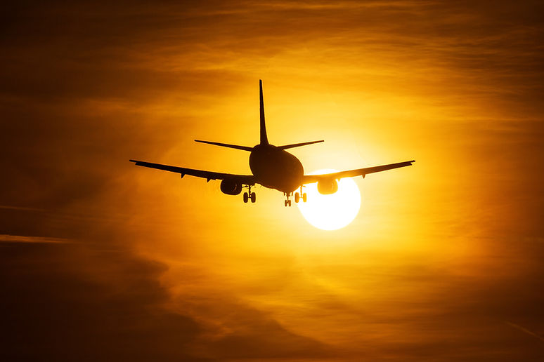 Airplane Taking Off at Sunset