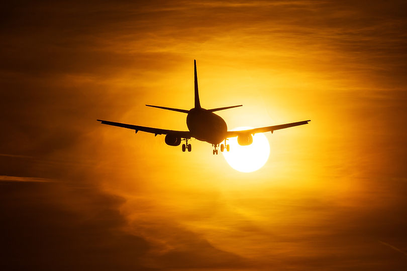 Airplane Taking Off at Sunset