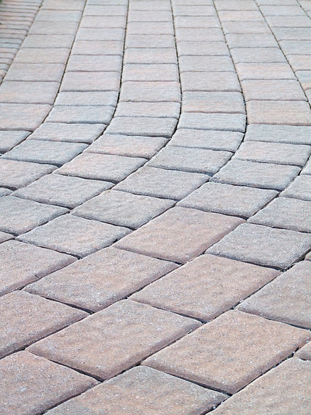 Winding cobblestone path with gray and beige stones, creating a gentle curve