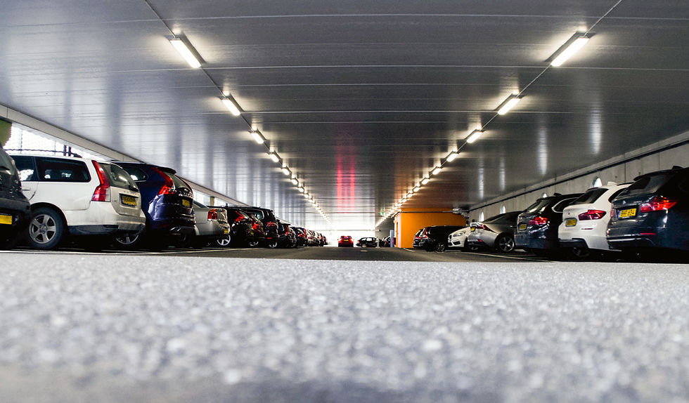Freshly paved parking lot with cars inside it.