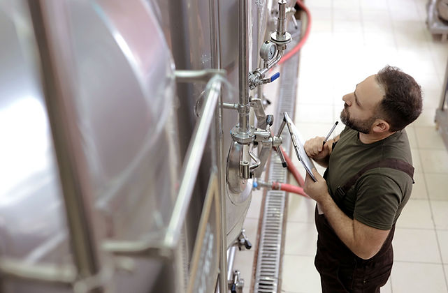 Man Inspecting Tanks