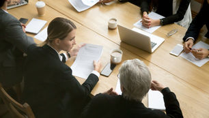 Ontario business partners reviewing a partnership agreement with a business lawyer