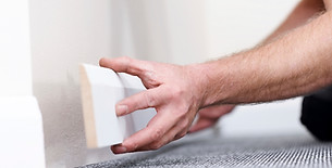 Handyman fitting wall skirting board