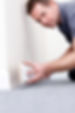 A professional installing wall skirting board