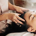 Woman getting a head massage at a spa