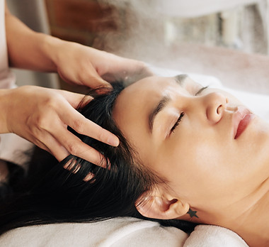 Woman getting a head massage at a spa