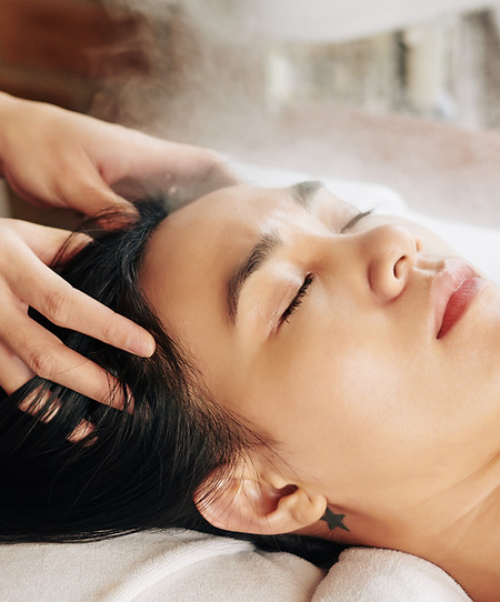 Woman getting a head massage at a spa