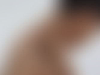 Woman with her back turned wearing a ring and earrings