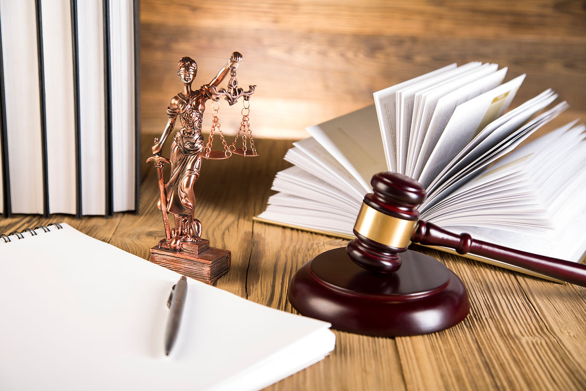 Lady of justice, gavel and books on wooden table