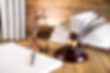 Gavel and books on wooden table
