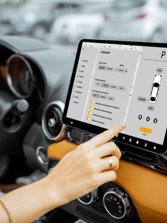 hand touching a touchscreen in a car