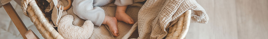 Baby in wicker cradle
