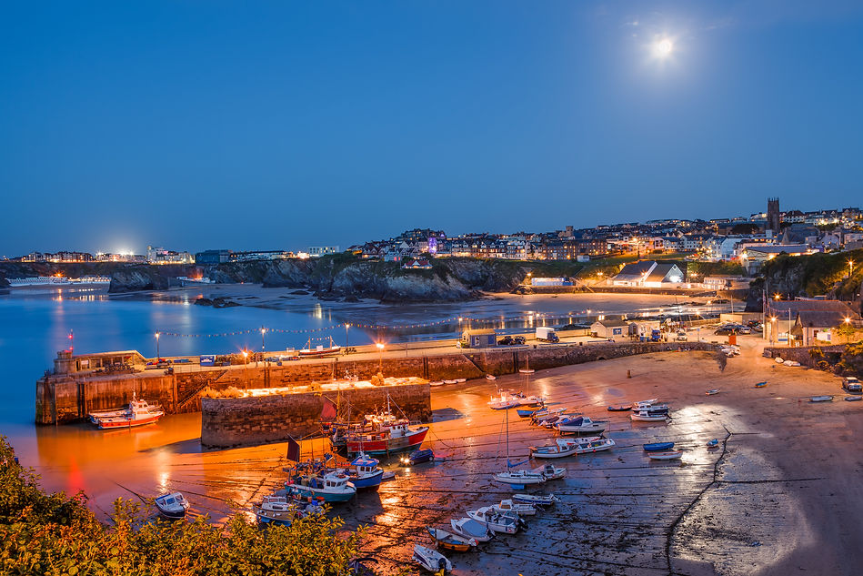 Full moon over the harbour and town at Newquay Cornwall England UK