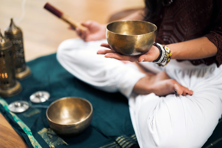 Practitioner demonstrating the mindful art of listening during a sound healing session.