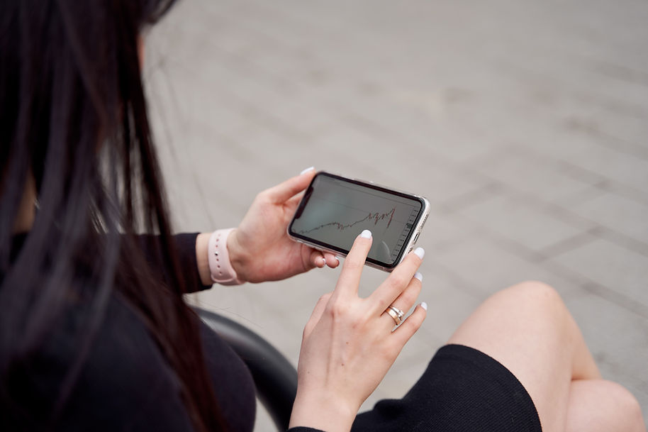 Person Checking Graphs on Smartphone