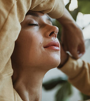 A portrait of a young person with a ring in the nose