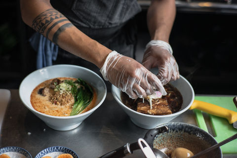 Chef preparing delicious ramen bowls