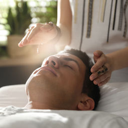 Individual receiving reiki services as a healing practice